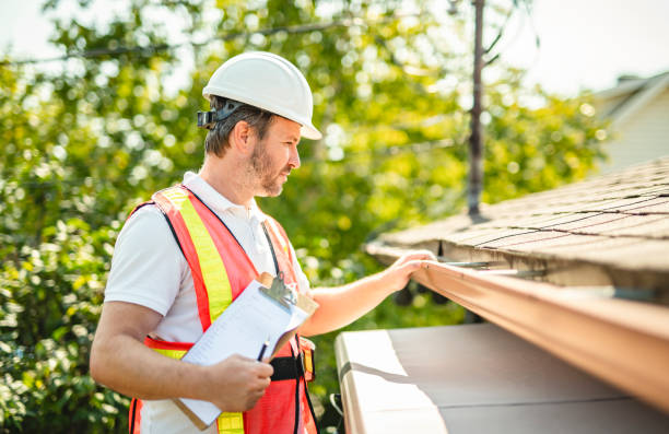 istock man with hard hat standing on steps inspecting house roof 2185916221
