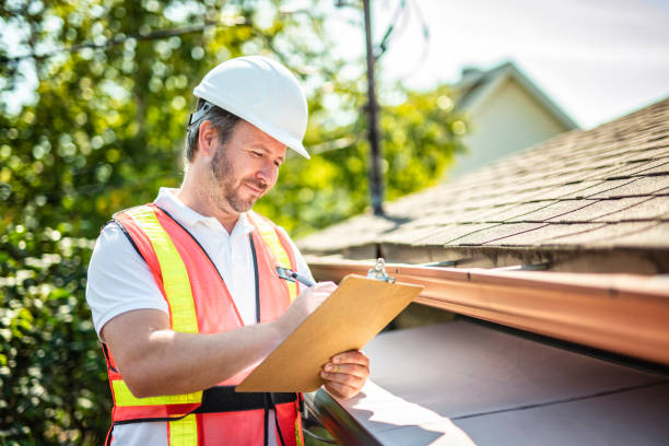 istock man with hard hat standing on steps inspecting house roof 2185916242
