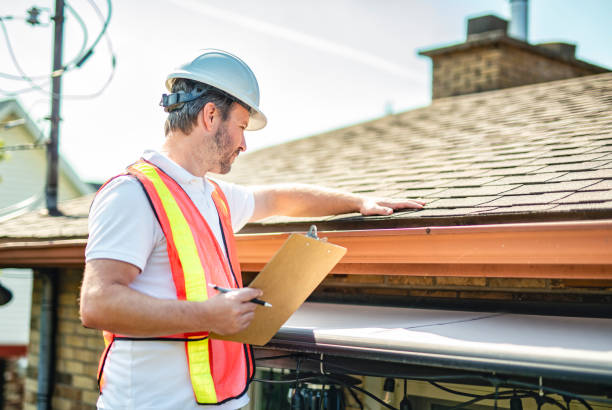 istock man with hard hat standing on steps inspecting house roof 2185916295