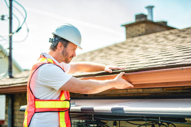 istock man with hard hat standing on steps inspecting house roof 2185916301