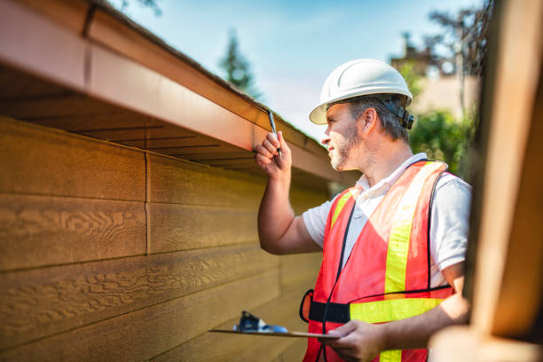 istock man with hard hat standing on steps inspecting house roof 2185916370