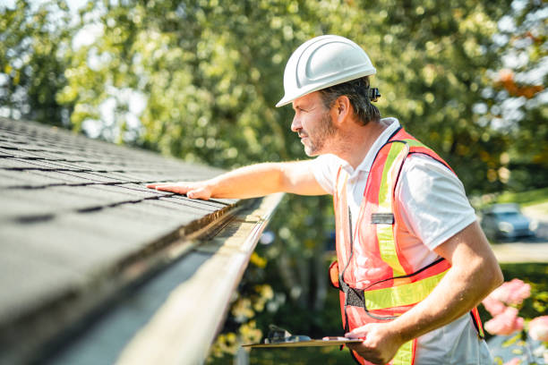 istock man with hard hat standing on steps inspecting house roof 2185916545
