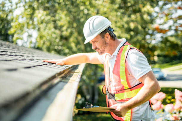 istock man with hard hat standing on steps inspecting house roof 2185916556