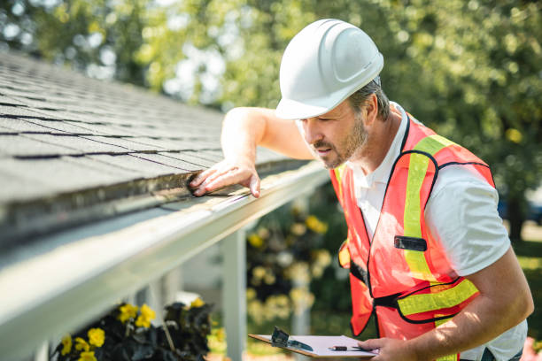 istock man with hard hat standing on steps inspecting house roof 2185916562