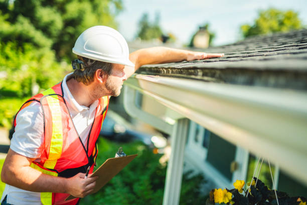 istock man with hard hat standing on steps inspecting house roof 2185916608