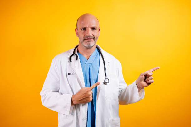 istock A self-assured doctor, pointing to the side. 2185916696