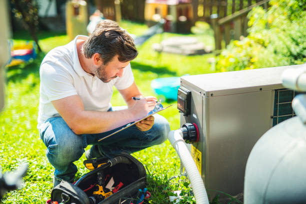 istock Electrician working on heat pump close to a pool 2185917519