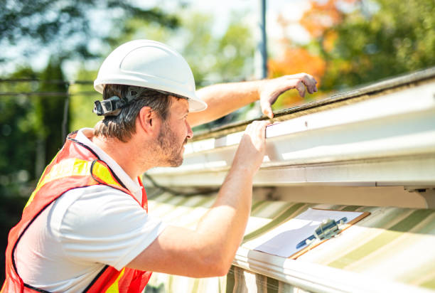 istock man with hard hat standing on steps inspecting house roof 2185917566