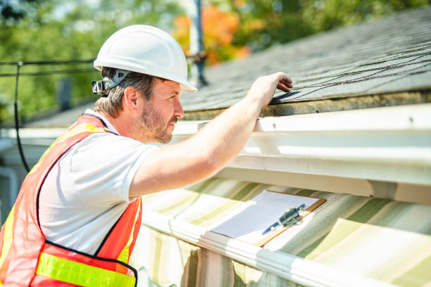 istock man with hard hat standing on steps inspecting house roof 2185917581