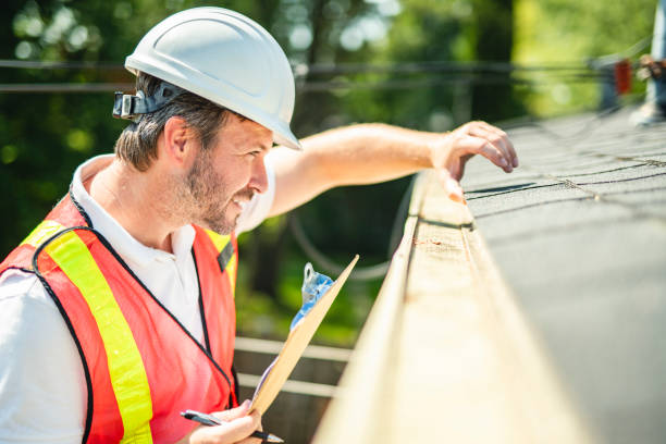 istock man with hard hat standing on steps inspecting house roof 2185920859