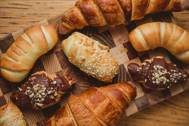 Croissants with chocolate filling on wooden background. Copy space.