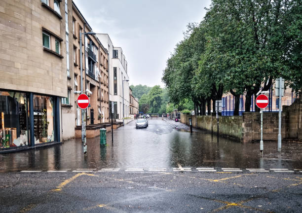 Torrential rain causing a large flood on a residential street in Glasgow, Scotland.
