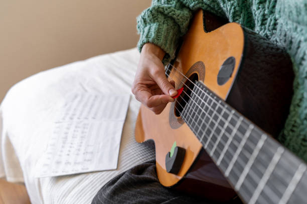 istock A woman playing a guitar 2185927254