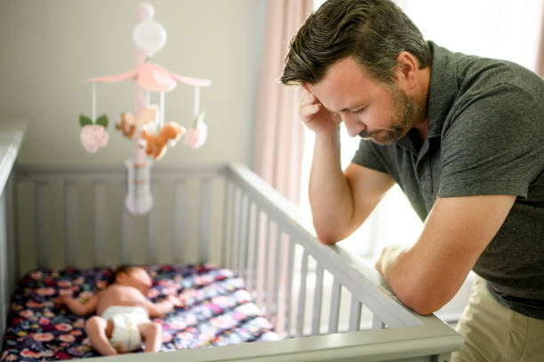 istock Tired father with Upset Baby Suffering with Post Natal Depression. 2185927706