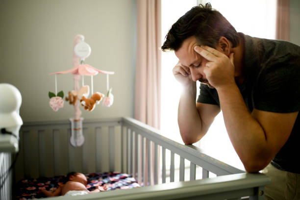 istock Tired father with Upset Baby Suffering with Post Natal Depression. 2185927709