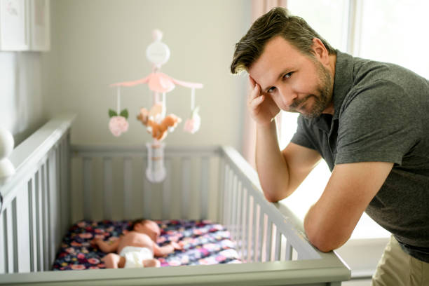 istock Tired father with Upset Baby Suffering with Post Natal Depression. 2185927711