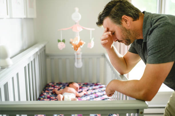 istock Tired father with Upset Baby Suffering with Post Natal Depression. 2185927716