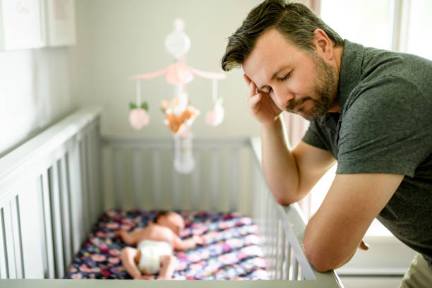 istock Tired father with Upset Baby Suffering with Post Natal Depression. 2185927726