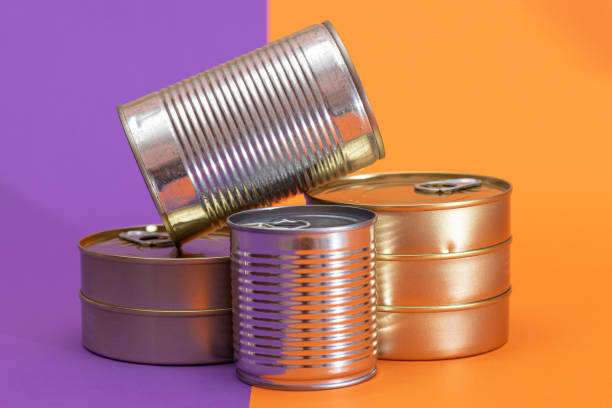 istock A Group of Stacked Tin Cans with Blank Edges on Split Orange and Violet Background 2185929708