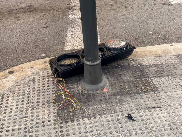 Broken stoplight lying down on the sidewalk