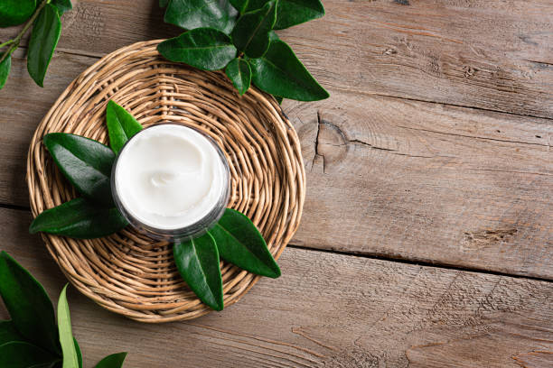 istock face cream in jar and green leaves 2185930826