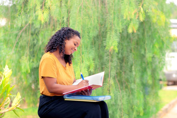 istock Black Brazilian Student Studying Outdoors on Campus 2185931050