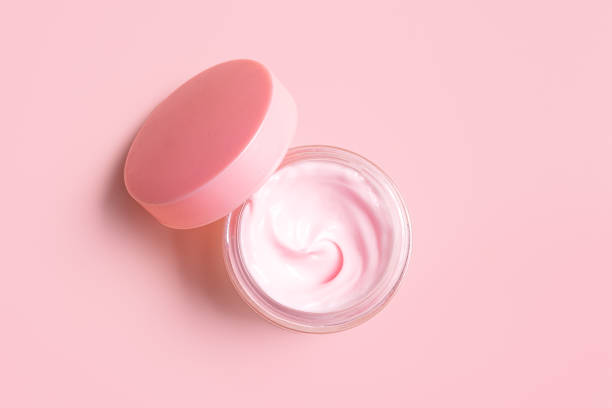 istock Open jar of pink cosmetic cream 2185931059