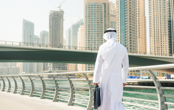 istock sheik man walking in dubai marina 2185931124