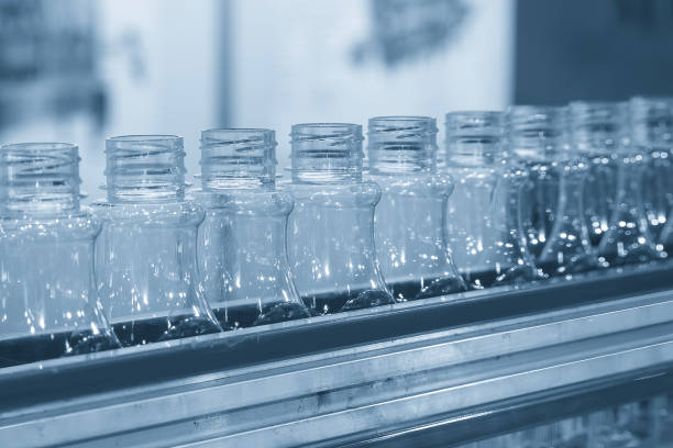 istock The  empty drinking water bottles  on the conveyor belt for filling process in the light blue scene. 2185931463