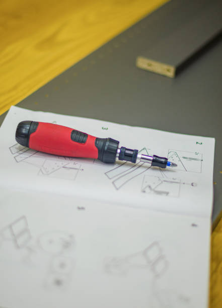 istock red with black screwdriver with manual on grey wood panel on wooden floor diy 2185932089