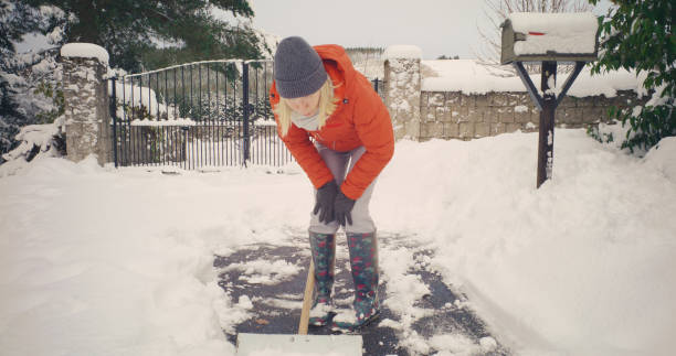 istock Senior woman backache shovelling snow 2185932631