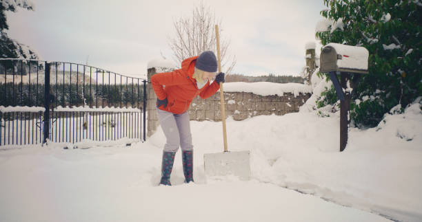 istock Senior woman backache shovelling snow 2185933357
