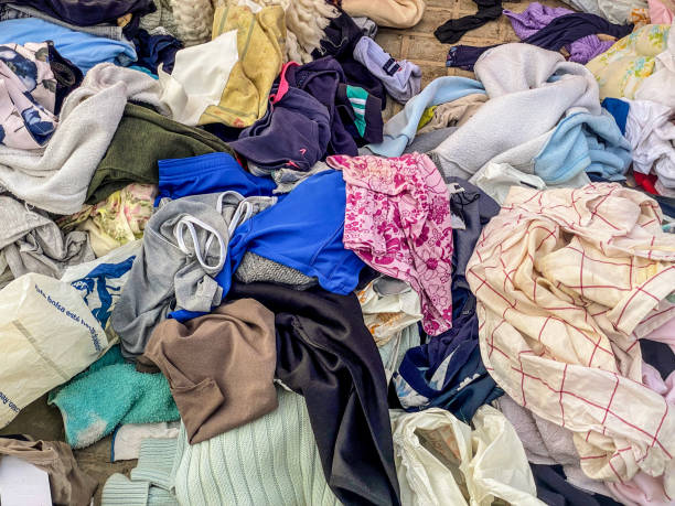 istock Lots of clothing thrown on the sidewalk 2185934231