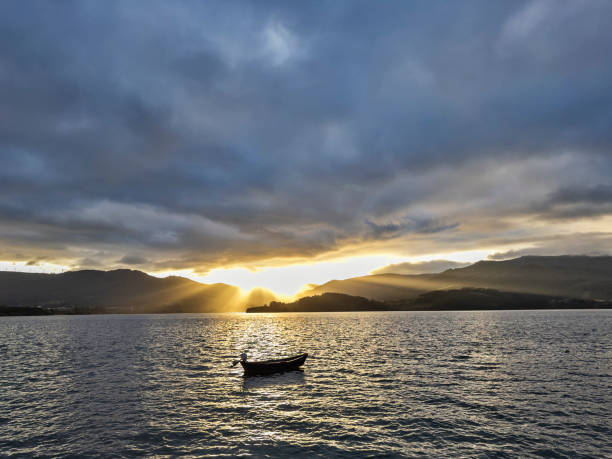 istock Serene Sunset Over Lake with Boat 2185943007