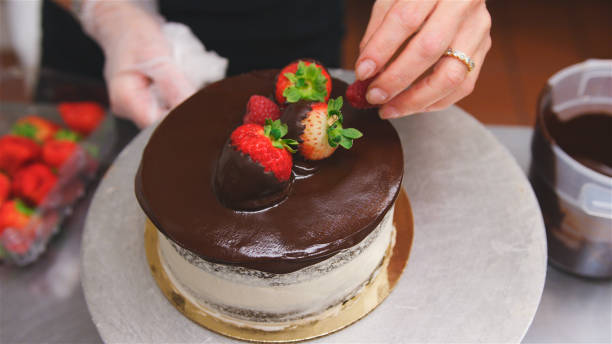 istock Baker Dipping Strawberries In Chocolate For Cake Decoration 2185943974