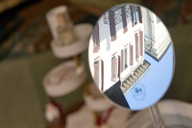 Close up reflection in a beaker of senior scientist working in laboratory.