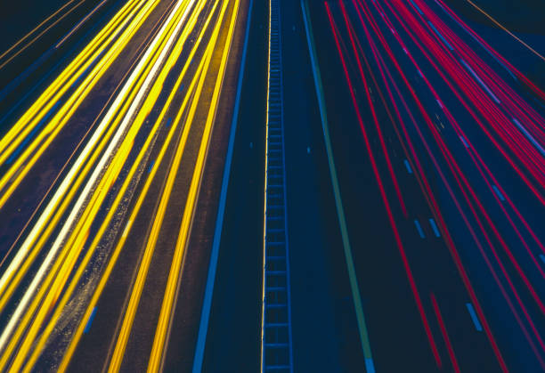 Light trails on the highway at night. Rush hour on motorway with glowing cars headlamps, long exposure