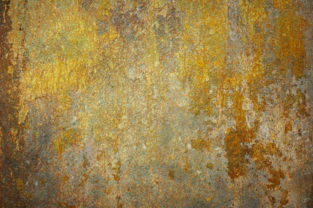 A close-up of a rusty brown wall featuring weathered textures, scratches, and stains. The surface showcases a distressed, old-fashioned look with a grunge photographic effect, ideal for use as a retro-style background or abstract design element with a rustic charm.