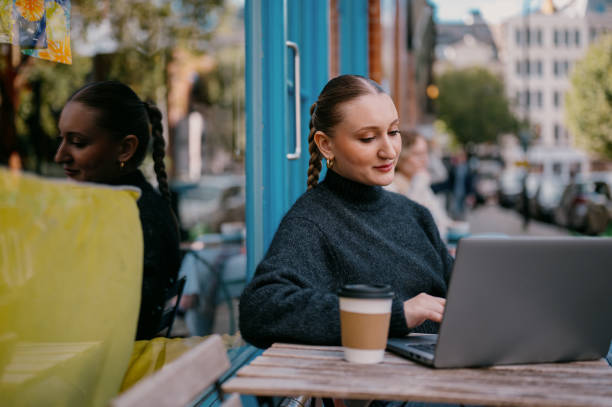 istock Young woman using her laptop at a cafe 2185952087