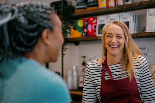 A barrista smiles at a customer she's serving