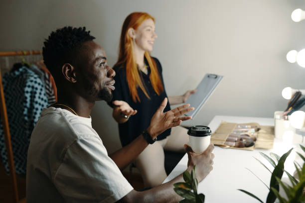 istock Engaging in Dressing Room Discussion Holding Tablet 2185953252