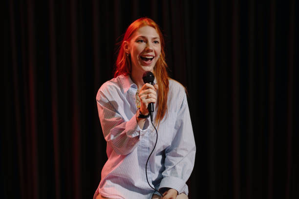 istock Smiling Woman Performing Stand-Up Comedy on Stage 2185953320