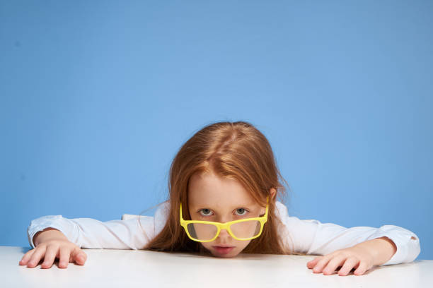istock emotional schoolgirl sitting at the table learning school 2185954996