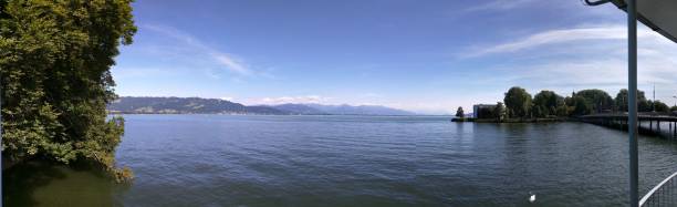 istock Panoramic view of Lake Constance with blue sky and mountains. 2185956349