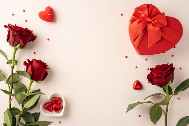 istock A romantic Valentine's Day setting featuring red roses, heart-shaped chocolates, and a gift box on a light background 2185957254