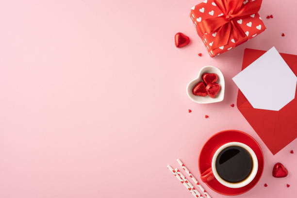 istock A romantic Valentine's Day setting featuring a wrapped gift, coffee, chocolates, and a card on a pink background. Perfect for expressing love and affection in a stylish way 2185957267
