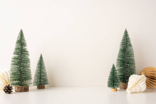 istock A side view serene, minimalist Christmas scene featuring snow-covered miniature trees and Scandinavian-style decor, evoking a peaceful winter holiday atmosphere 2185957300
