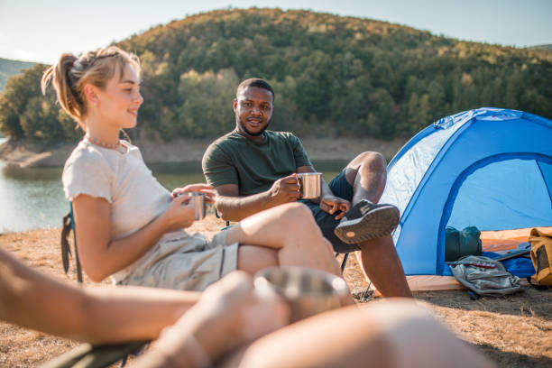 istock A smaller group of friends bond while camping by a lake 2185963921