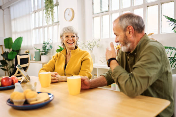 istock Happy senior couple enjoying breakfast and talking at home 2185969864