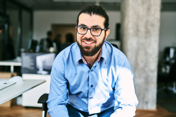 istock Confident male professional looking at camera and smiling at startup office 2185971590